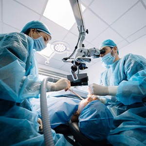 Dentists performing a dental implant surgery