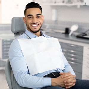 Patient smiling while sitting in treatment chair