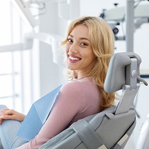 Woman smiling while sitting in treatment chair