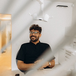 Patient smiling while sitting in treatment chair